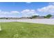 Large backyard enclosed by a white vinyl fence on a sunny day, ideal for outdoor activities and gatherings at 8978 Se 42Nd Ct, Ocala, FL 34480