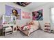 Unique bedroom design featuring colorful artwork, lighted vanity, and comfortable sleeping area at 8978 Se 42Nd Ct, Ocala, FL 34480