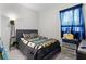 Well-lit bedroom with carpeted floor and featuring a comfortable bed, and window at 8978 Se 42Nd Ct, Ocala, FL 34480