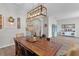 Dining room with a rustic wooden table, stylish chairs, and modern light fixture at 8978 Se 42Nd Ct, Ocala, FL 34480