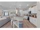 Bright kitchen boasts white cabinets, granite countertops, stainless steel appliances, and a breakfast bar with modern pendant lighting at 8978 Se 42Nd Ct, Ocala, FL 34480