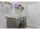 Bright laundry room features modern washer and dryer set, shelving and a tiled floor at 8978 Se 42Nd Ct, Ocala, FL 34480