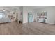 Open-concept living space with modern wood flooring, stylish furnishings, and decorative accents at 8978 Se 42Nd Ct, Ocala, FL 34480