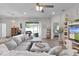 Bright, open living room with sliding glass doors to the lanai, leading to the kitchen and bedroom at 8978 Se 42Nd Ct, Ocala, FL 34480