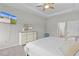 The Main bedroom features tray ceiling, a ceiling fan, dresser, and a television screen for viewing pleasure at 8978 Se 42Nd Ct, Ocala, FL 34480