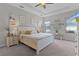 Spacious main bedroom with carpet, ceiling fan, dresser, nightstands and many windows at 8978 Se 42Nd Ct, Ocala, FL 34480