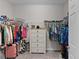 Spacious walk-in closet featuring wire shelving, hanging clothes, shelving, and a dresser for storage at 8978 Se 42Nd Ct, Ocala, FL 34480