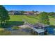 Aerial view of lakeside property featuring a private dock with covered seating and beautiful landscaping at 9648 Weatherstone, Windermere, FL 34786