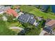 Aerial view of a home with screened pool, surrounded by lush landscaping and neighboring properties at 9648 Weatherstone, Windermere, FL 34786