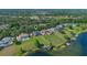 Aerial shot of lakefront homes with lush green yards and private docks, and a green map marker at 9648 Weatherstone, Windermere, FL 34786