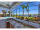 Covered outdoor bar with a countertop, seating, and a picturesque view of the lake at 9648 Weatherstone, Windermere, FL 34786