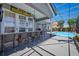 Outdoor bar area with seating, a Steelers sign, and a view of the pool and backyard at 9648 Weatherstone, Windermere, FL 34786