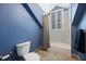 Blue toned bathroom with a shower-tub combo, patterned tile, and a toilet at 9648 Weatherstone, Windermere, FL 34786