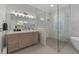 Elegant bathroom features custom vanity, marble countertop, and glass-enclosed shower at 9648 Weatherstone, Windermere, FL 34786