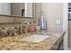 Bathroom sink featuring granite counters, brushed nickel faucet, and decorative mirror at 9648 Weatherstone, Windermere, FL 34786