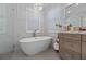 Refined bathroom featuring a freestanding tub, a chandelier and a custom vanity at 9648 Weatherstone, Windermere, FL 34786