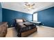 Blue bedroom featuring a wooden bed frame, window seat, and ceiling fan at 9648 Weatherstone, Windermere, FL 34786