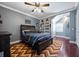 Comfortable bedroom featuring a wood frame bed, ceiling fan, and gray walls with white trim at 9648 Weatherstone, Windermere, FL 34786