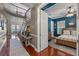 Foyer leading to a bedroom with blue walls, hardwood floors, and a ceiling fan at 9648 Weatherstone, Windermere, FL 34786