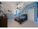 Blue bedroom with a ceiling fan, window seat, and decor with wooden dresser at 9648 Weatherstone, Windermere, FL 34786