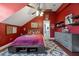Red bedroom with a ceiling fan, sports decor, and a view into the attached bathroom at 9648 Weatherstone, Windermere, FL 34786