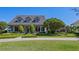 Beautiful exterior showcasing a well-maintained lawn and landscaped garden in front at 9648 Weatherstone, Windermere, FL 34786