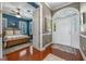 Foyer leading to a bedroom with blue walls, hardwood floors, and a front entry at 9648 Weatherstone, Windermere, FL 34786