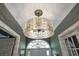 Elegant foyer featuring a modern chandelier and a glass-paneled door with a semicircular transom window at 9648 Weatherstone, Windermere, FL 34786
