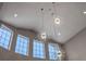 Bright foyer features modern, starburst chandeliers and large windows that bring in natural light at 9648 Weatherstone, Windermere, FL 34786