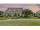 Charming single-story home featuring a welcoming front porch, beautiful columns, and manicured landscaping at 9648 Weatherstone, Windermere, FL 34786