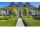 Charming home with a lush front yard and welcoming porch with columns at 9648 Weatherstone, Windermere, FL 34786