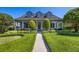 Inviting home featuring a classic design, landscaped yard, and a spacious front porch at 9648 Weatherstone, Windermere, FL 34786