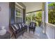 Inviting front porch featuring wicker furniture and views of the surrounding greenery at 9648 Weatherstone, Windermere, FL 34786