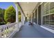 Long front porch with pillars, with potted plants and decor at 9648 Weatherstone, Windermere, FL 34786