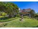 Charming home featuring a well-manicured front yard with a decorative fountain and lush landscaping at 9648 Weatherstone, Windermere, FL 34786