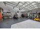 Spacious garage with epoxy flooring, work benches, and storage space for tools and equipment at 9648 Weatherstone, Windermere, FL 34786