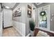 Hallway features wood floors, a decorative plant, and a white front door with glass and a wreath at 9648 Weatherstone, Windermere, FL 34786