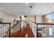 Bright and spacious hallway boasts wood floors, elegant lighting, and access to multiple rooms, and stylish Gathering photographs at 9648 Weatherstone, Windermere, FL 34786