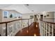Open hallway with dark wood floors, modern light fixtures, and large windows offering plenty of natural light at 9648 Weatherstone, Windermere, FL 34786