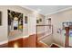 Second floor hallway with hardwood floors and sports decor in an adjoining room at 9648 Weatherstone, Windermere, FL 34786