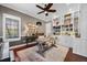 Comfortable home office featuring a ceiling fan, natural light, stylish decor, and custom built-in shelves at 9648 Weatherstone, Windermere, FL 34786