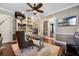 Inviting home office featuring custom built-ins, hardwood floors, ceiling fan, and a neutral color scheme at 9648 Weatherstone, Windermere, FL 34786