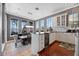 Bright kitchen boasts white cabinetry, hardwood floors, and large windows overlooking the water at 9648 Weatherstone, Windermere, FL 34786