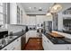 Bright kitchen with stainless steel appliances, black countertops, and ample cabinet space for storage at 9648 Weatherstone, Windermere, FL 34786