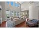 Bright and airy living room with water views, high ceilings, and a plush sectional sofa at 9648 Weatherstone, Windermere, FL 34786