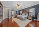 Comfortable main bedroom with hardwood floors, natural light, and calming decor at 9648 Weatherstone, Windermere, FL 34786