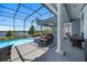 Outdoor pool and patio area with ample seating, dining space, and a view of the lake at 9648 Weatherstone, Windermere, FL 34786