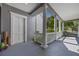 View from the porch with white columns, a green lawn, and a peek at neighborhood trees at 9648 Weatherstone, Windermere, FL 34786