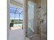 Bathroom shower area showcasing glass doors, herringbone pattern tile, and outdoor pool view at 9648 Weatherstone, Windermere, FL 34786