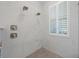 Beautifully tiled shower with dual shower heads and a built-in seat at 9648 Weatherstone, Windermere, FL 34786